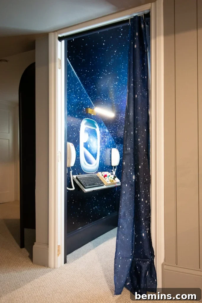 Launch Their Imagination: 20 Ultimate Space-Themed Kids Room Ideas 16 A child's command center desk in a space-themed room, equipped with planetary decor and learning tools, perfect for young explorers.