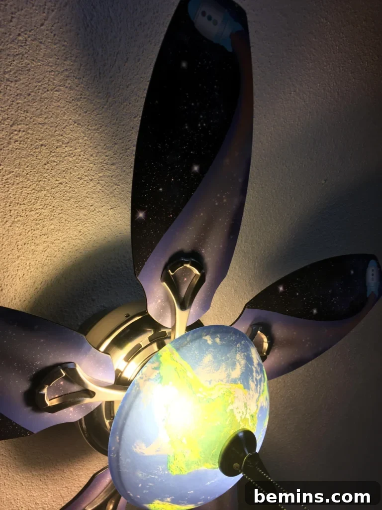 Launch Their Imagination: 20 Ultimate Space-Themed Kids Room Ideas 23 A ceiling fan with its blades artistically painted with stars and celestial patterns, adding a unique cosmic touch to the room.