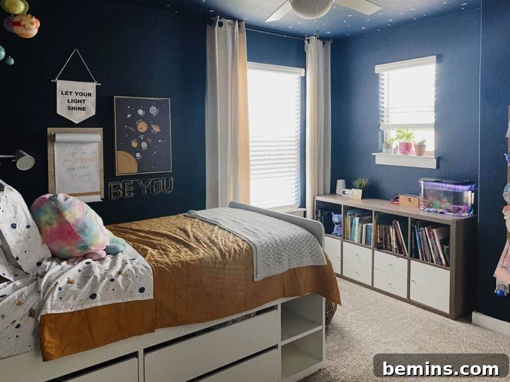 Launch Their Imagination: 20 Ultimate Space-Themed Kids Room Ideas 7 A kid's room featuring deep blue painted walls, providing a rich, calming backdrop that evokes the vastness of space.