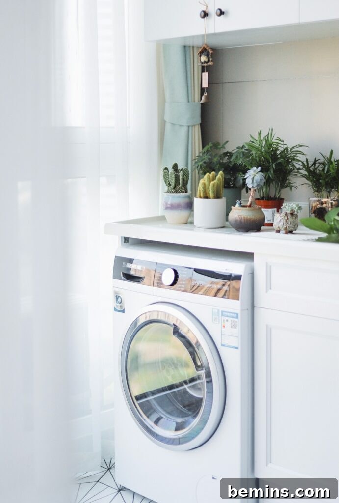 Sustainable, Eco-Friendly Alternatives to Dryer Sheets 3 A modern laundry setup featuring a white front-load washing machine and minimalist cabinets.