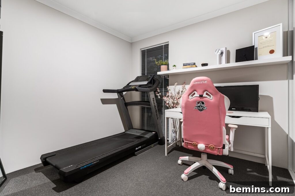 Maximizing Your Small Space: Smart Home Gym Design Ideas 13 A room with a treadmill and a desk