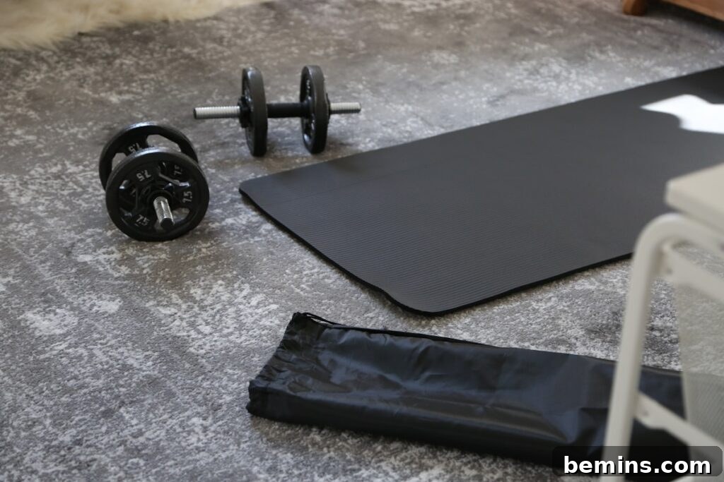 Maximizing Your Small Space: Smart Home Gym Design Ideas 14 a pair of dumbbells and a black mat on the floor