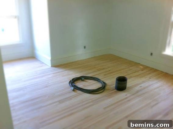 The bedroom after sanding floors and priming walls, ready for paint.