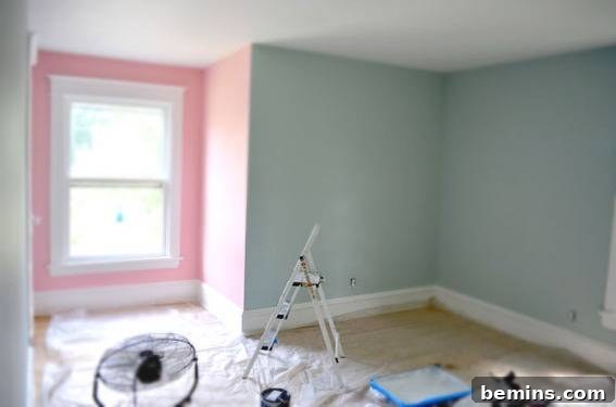 Bedroom with pink and blue/green paint, creating a calming atmosphere.