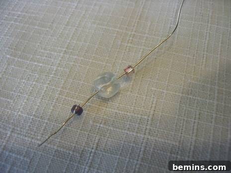 Someone explaining how to make beaded wire garland.
