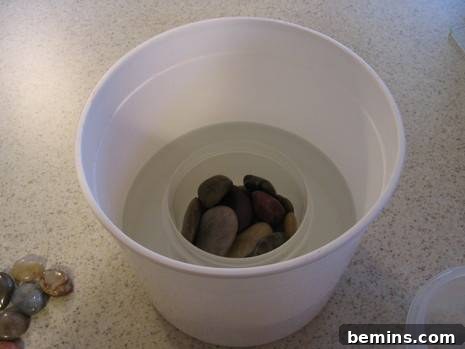 Stylish Outdoor Lighting: Complimentary 3 Rocks are strategically placed inside the smaller white container, which is nested within a larger bucket, ensuring it remains stable and centered.