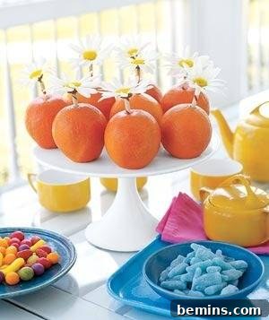 Simple spring centerpiece with citrus fruits in a hurricane vase