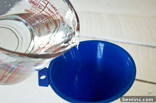 Adding water to the spray bottle already containing dish soap