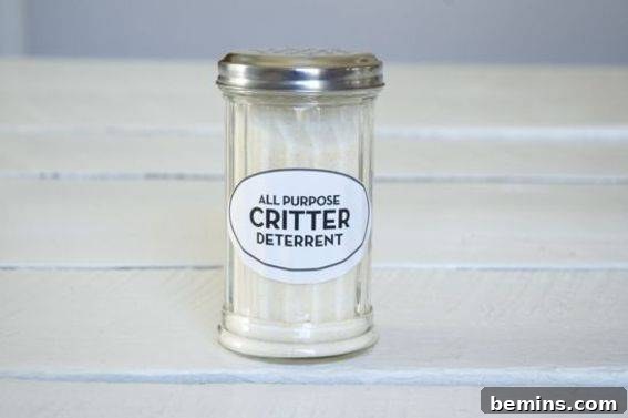 A shaker bottle filled with garlic salt, labeled for critter deterrence