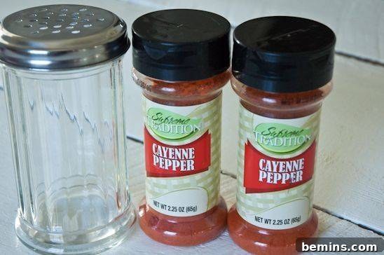 Make Your Own Affordable Natural Garden Pest Control 18 Hands carefully sprinkling garlic salt onto the soil around the base of a garden plant
