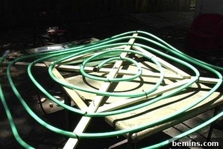 Garden hose secured to the frame with cable ties