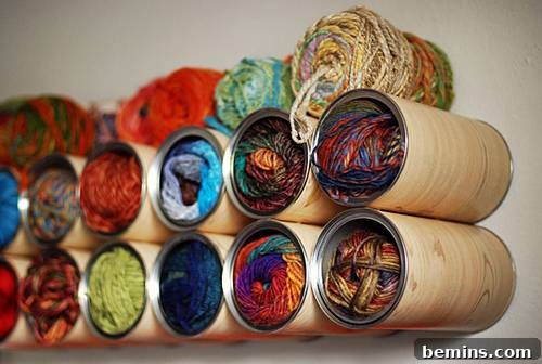 Reimagine Your Walls: 10 Upcycled DIY Art Projects 12 Cylinders full of yarn attached to a wall.