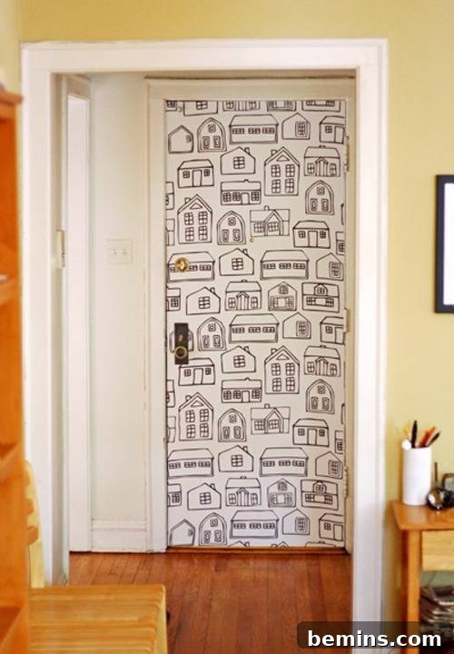 Reimagine Your Walls: 10 Upcycled DIY Art Projects 9 A door in a house with drawings of houses covering it.