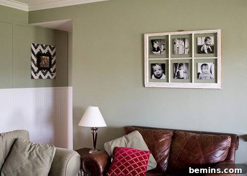 Multiple photo frame on wall beside couch.
