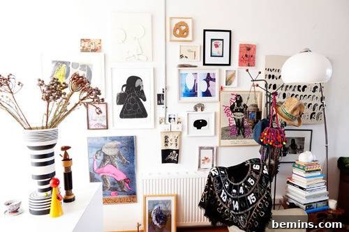 A captivating gallery wall display featuring an array of picture frames thoughtfully arranged on a pristine white wall, creating a striking visual impact.