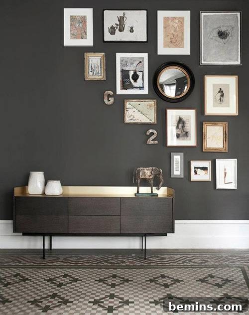 A short grey table strategically placed in a room with coordinating grey walls, adorned with a captivating gallery wall display that enhances the room's sophisticated ambiance.
