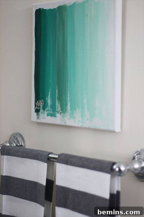 DIY Wall Decor: 10 Vibrant Art Projects to Personalize Your Space 11 Green ombre wall art displayed behind a towel bar in a bathroom setting.