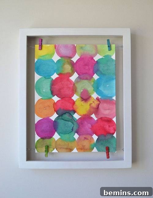 DIY Wall Decor: 10 Vibrant Art Projects to Personalize Your Space 4 A colorful DIY framed watercolor painting featuring abstract circles.