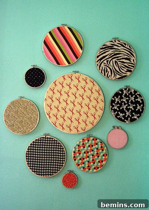 DIY Wall Decor: 10 Vibrant Art Projects to Personalize Your Space 10 Ten different sized embroidery hoops with fabric patterns displayed on a teal wall.