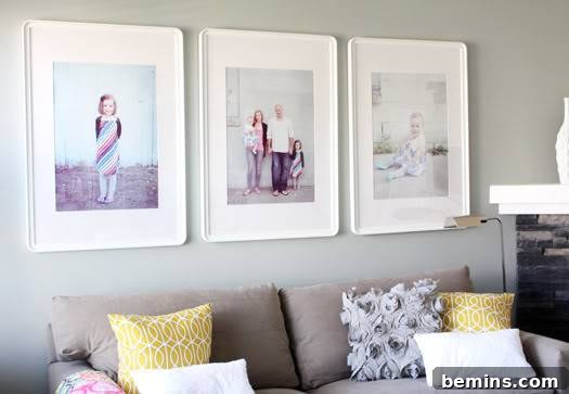 Three framed black and white family photos hanging above a couch, creating a stylish and personal focal point in the living room.
