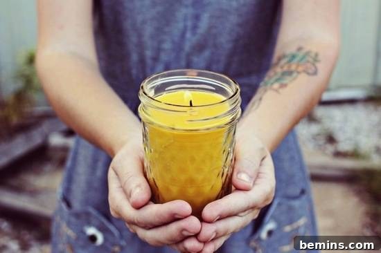 20 Heartfelt DIY Gifts for Mom 21 A woman is holding a lit, yellow candle.