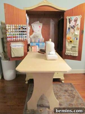 An open cupboard with a table coming out of it. A DIY sewing cabinet ready for work.