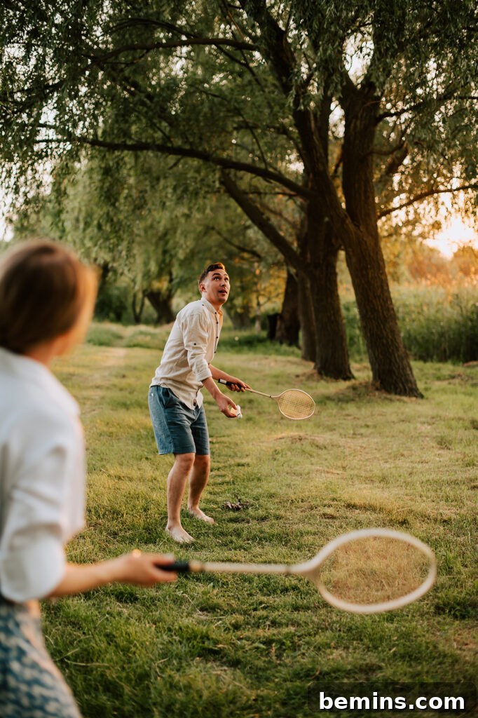 Hilarious Outdoor Games for Grown-Ups: Camping and Beyond 2 Friends playing badminton outdoors on a sunny day, enjoying a fun backyard game together.
