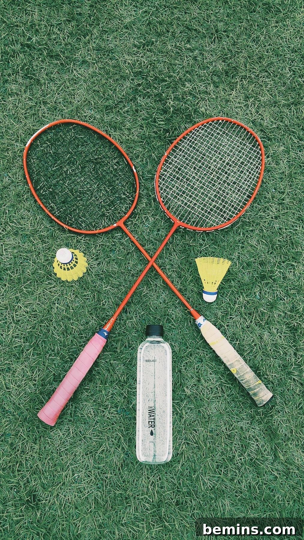 Hilarious Outdoor Games for Grown-Ups: Camping and Beyond 4 Badminton rackets and shuttlecocks arranged on a net, ready for a fast-paced game.