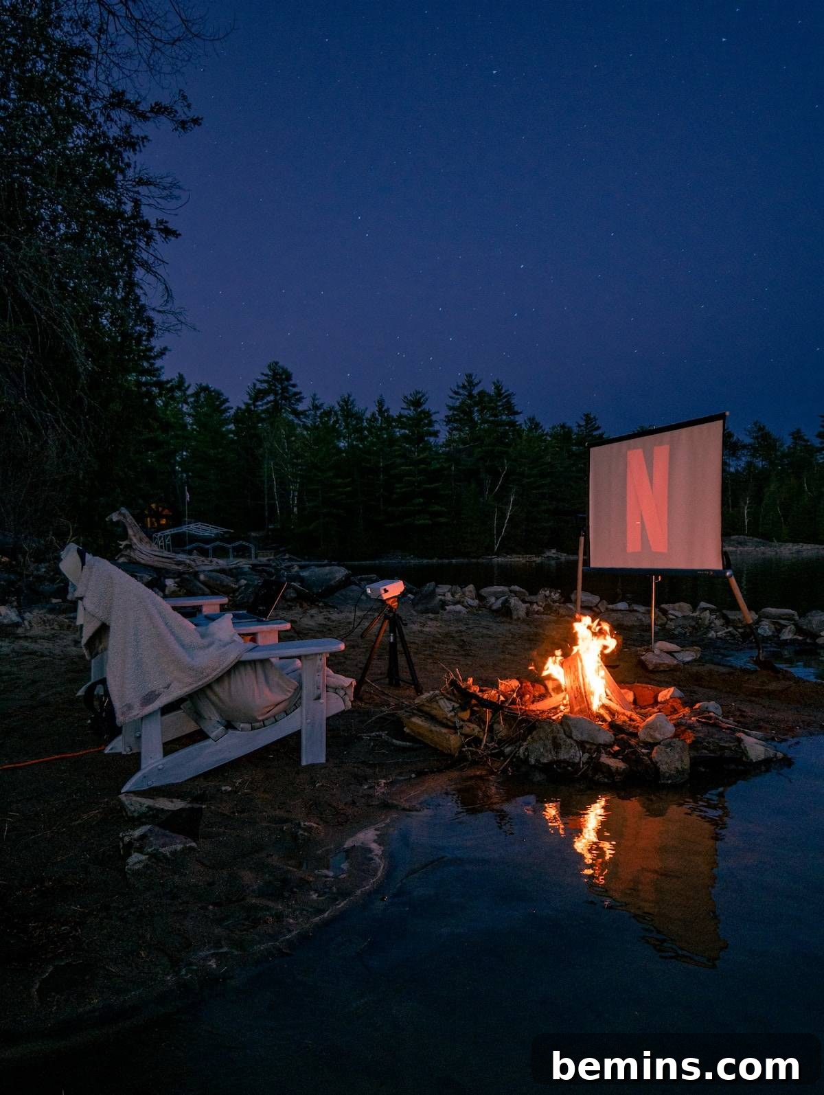 Hilarious Outdoor Games for Grown-Ups: Camping and Beyond 9 A group of friends enjoying an outdoor movie night with popcorn and blankets.