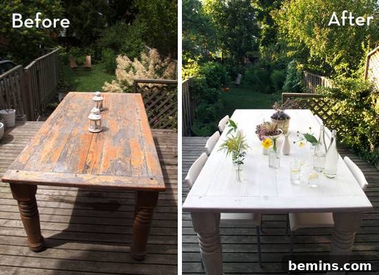 A flaking dining room table has been painted white and has white chairs with it.