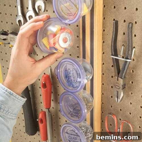 Garage Makeover: 10 DIY Organization Hacks 6 Plastic jars with magnetic attachments stuck to a metal board.