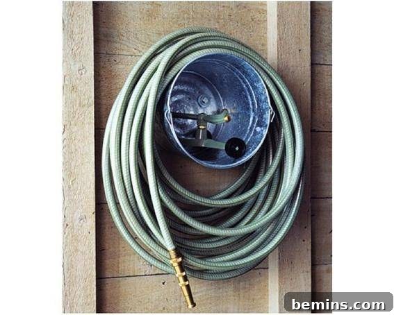 Garage Makeover: 10 DIY Organization Hacks 9 Garden hose coiled around a bucket attached to a wall.