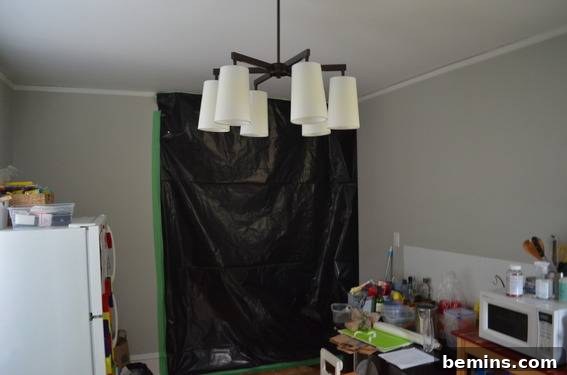 A black tarp covering a doorway in a kitchen.