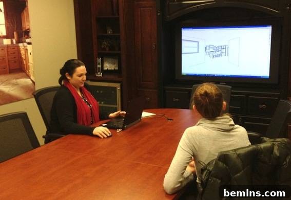 Two women designing a kitchen on a large screen TV.