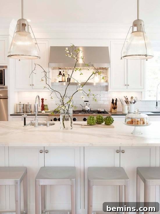 A kitchen with bar stools under an island.