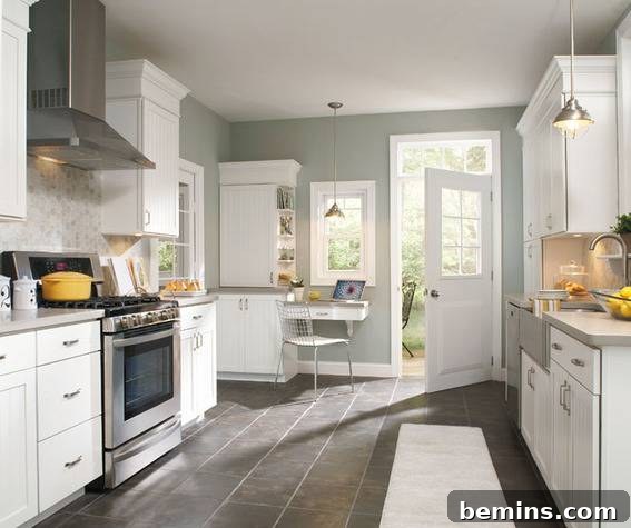 A kitchen with white counters and cabinets and grey walls.