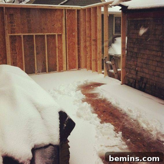 The top floor of the house covered in snow, without a roof.
