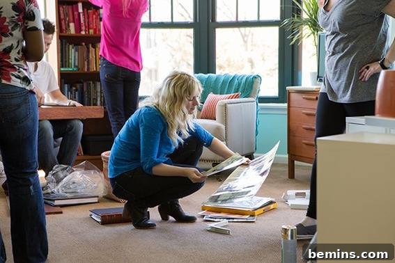 A group of individuals collaborating in a senior living room, surrounded by books and design materials, fostering a sense of community and creativity.