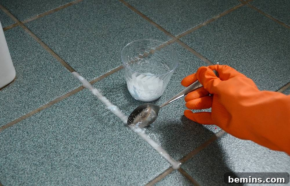 OxiClean cleaner being prepared for grout cleaning, showing the mixing process with water.