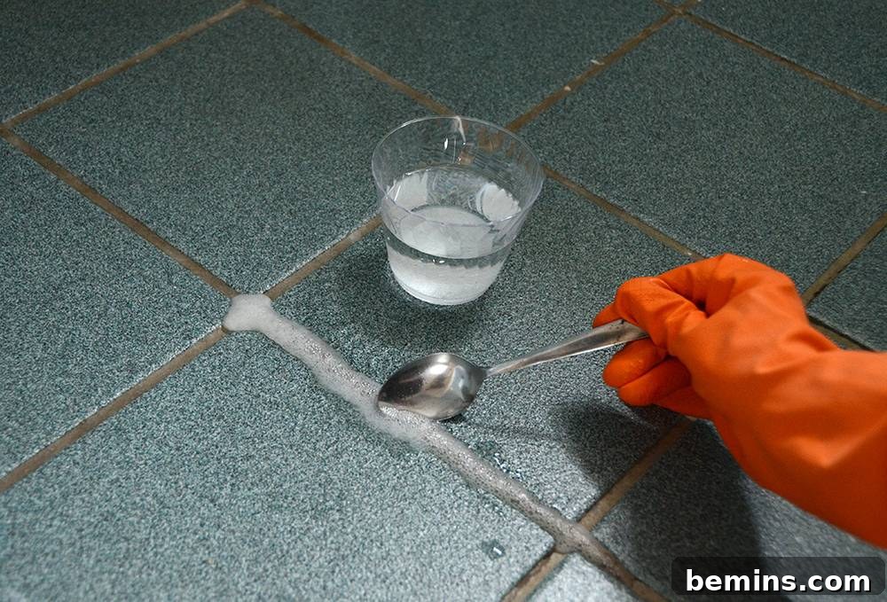 Sulfamic acid cleaner being used to clean grout, emphasizing the importance of safety precautions.