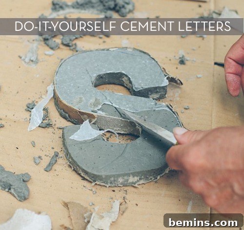 A letter S being carved out of cement.