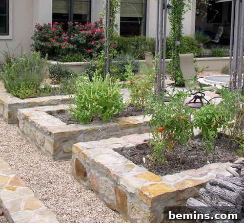 Beautiful stone raised garden beds filled with a variety of vibrant plants and lush dirt, enhancing the outdoor aesthetic.
