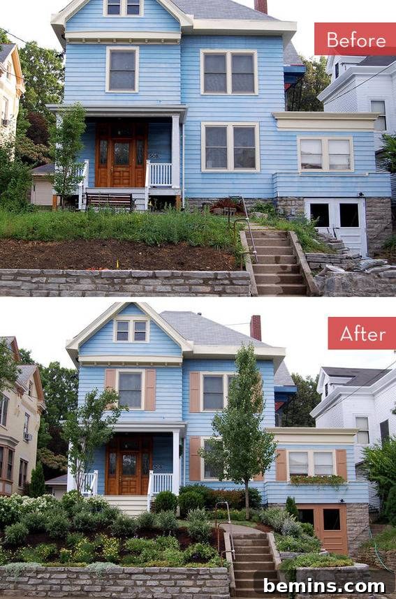 A blue two-story house with strategically placed trees and colorful shrubs.