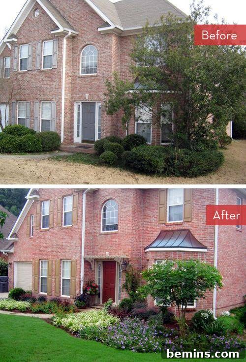 A brick two-story home with a beautifully kept yard featuring colorful flowers.