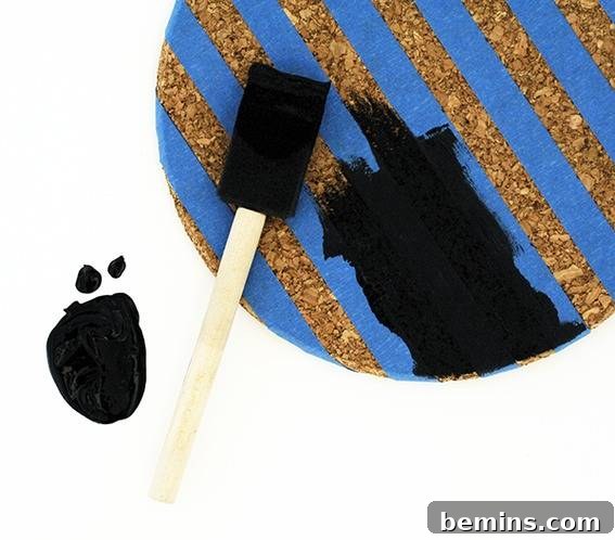 A white brown and blue painting that has some black smudges.