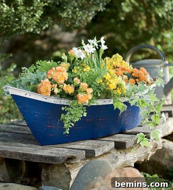 Flowers blooming in a blue toy boat planter on wooden slats.
