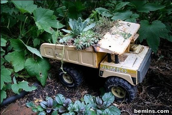 Small metal dump truck repurposed as a flower planter.
