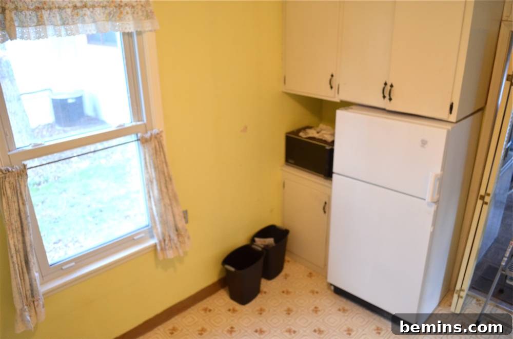 Before: The refrigerator positioned on the right, blocking the entry.