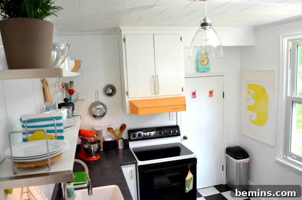 During: A kitchen with white walls and a window, awaiting transformation.