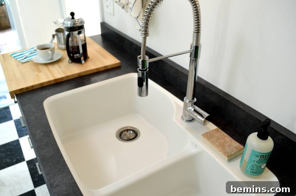 A close-up of the integrated white sink basin and dark counter, showcasing the seamless design.
